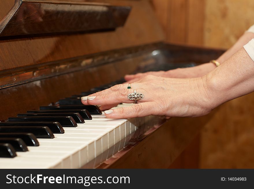 A caucasian woman's hand playing a keyboard. A caucasian woman's hand playing a keyboard
