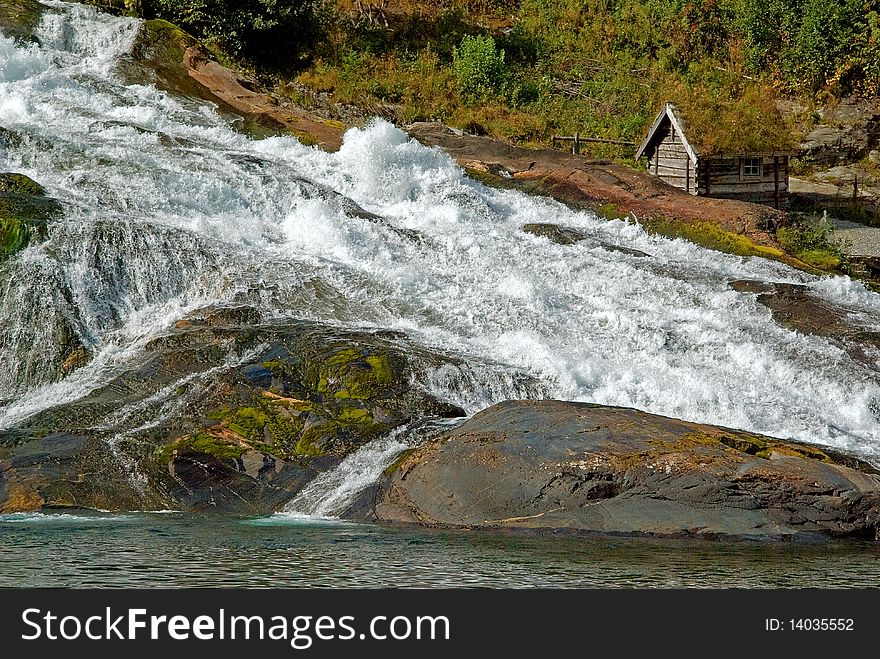 Landscape in Norway with waterfall and a small shack. Landscape in Norway with waterfall and a small shack.