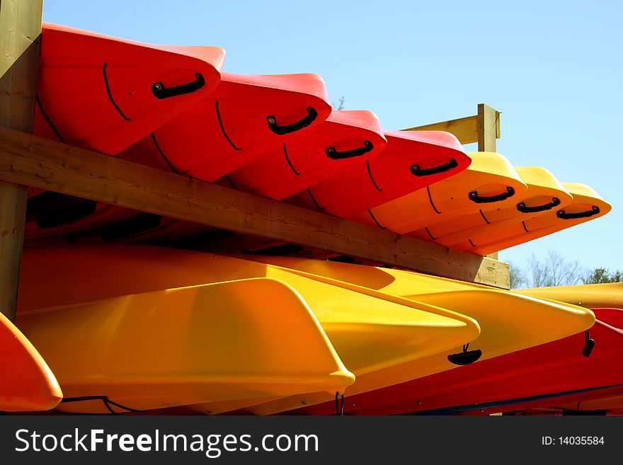 Kayaks sitting on wooden rack. Kayaks sitting on wooden rack.