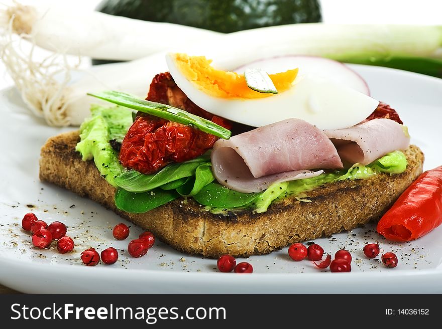 Toast with egg, ham, salad and tomato. Toast with egg, ham, salad and tomato