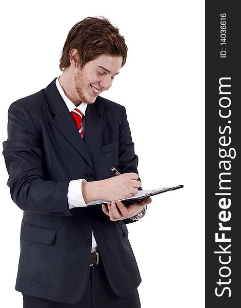 Handsome Businessman in black outfit shot in studio isolated on white - writing on clipboard. Handsome Businessman in black outfit shot in studio isolated on white - writing on clipboard