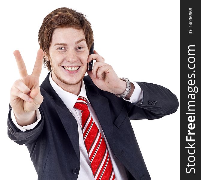 Picture of a businessman making victory sign while talking on the phone