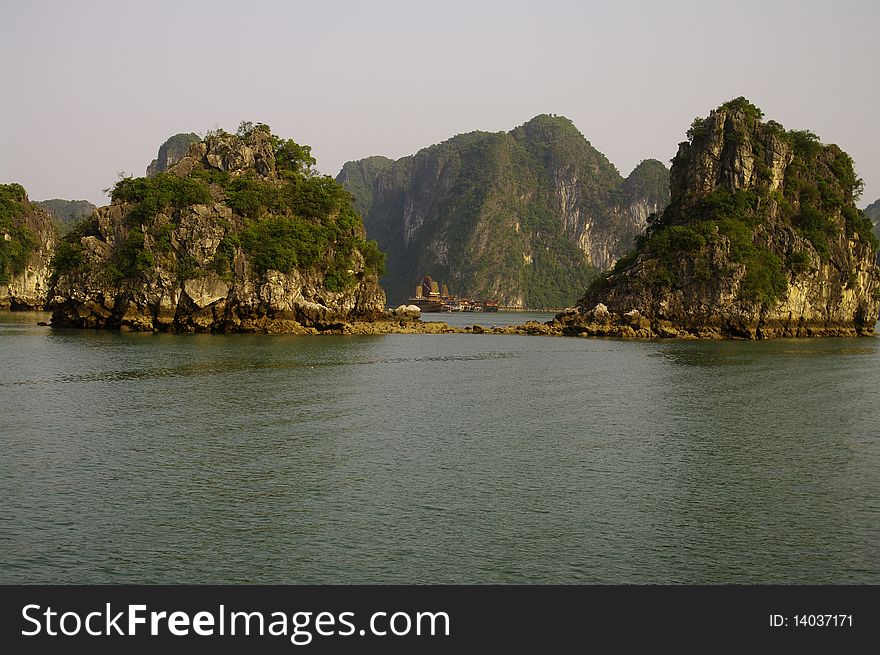 Halong Bay and its countless cruise ships. Beautiful site with rocks on Wed Wooden boats sail sometimes with junk. Halong Bay and its countless cruise ships. Beautiful site with rocks on Wed Wooden boats sail sometimes with junk