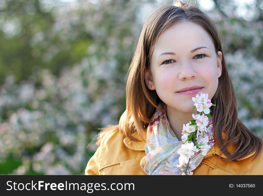 Young woman in blooming park