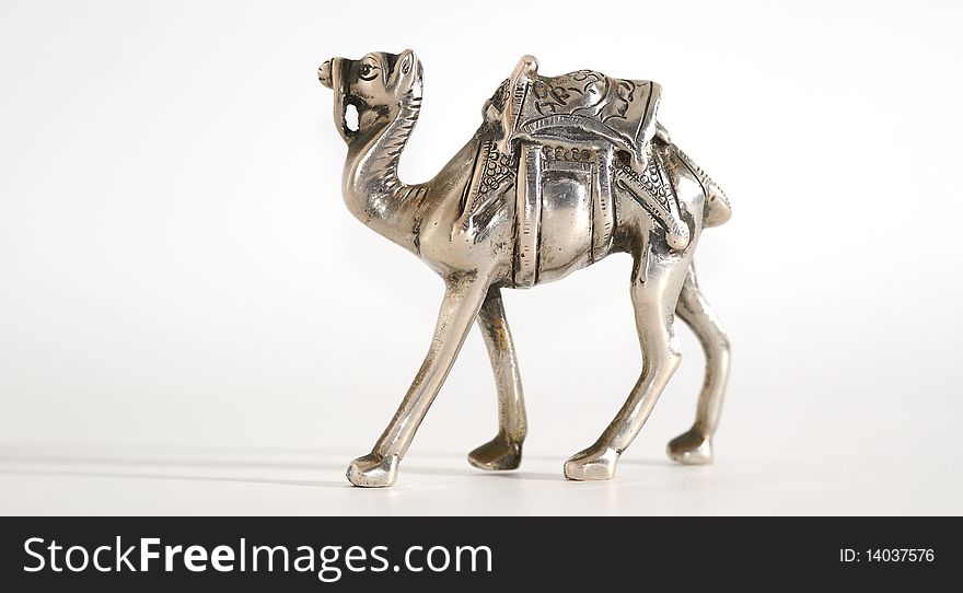 Souvenir figurine of a camel made of metal, isolation