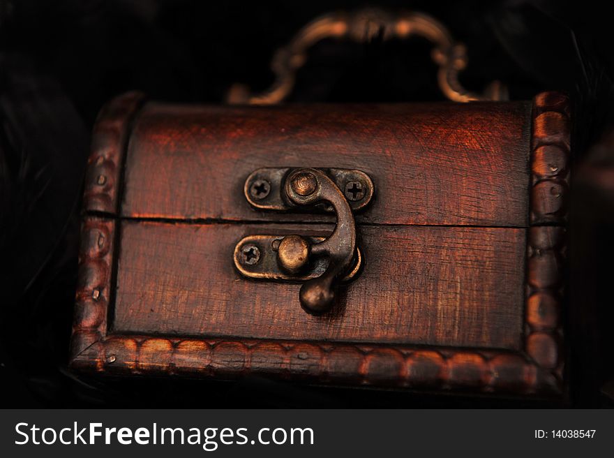 Closed small brown miniature treasure chest. Closed small brown miniature treasure chest