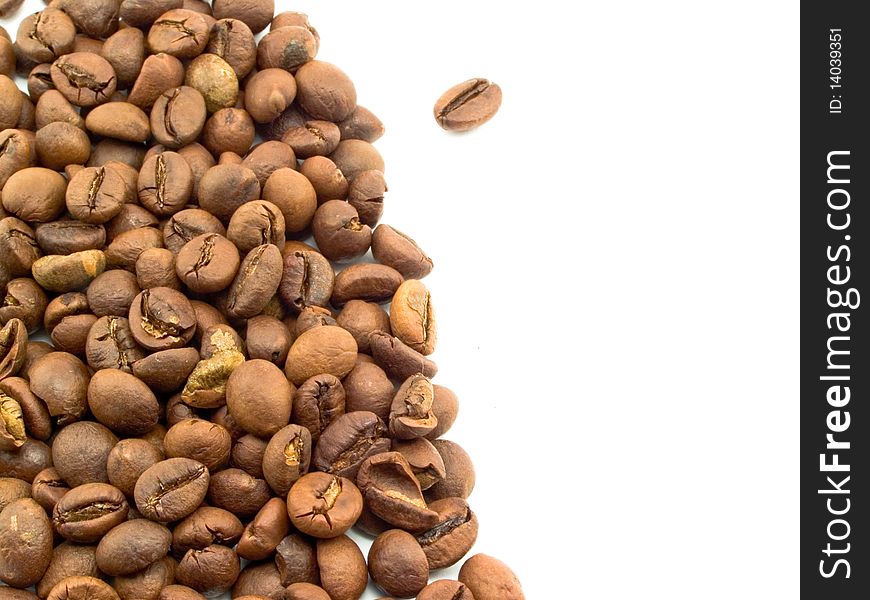 Roasted brown aromatic coffee grain is sprinkled on white background. Roasted brown aromatic coffee grain is sprinkled on white background