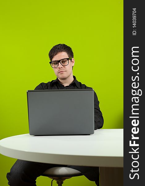 Young man sitting in the office and working on the laptop. Young man sitting in the office and working on the laptop