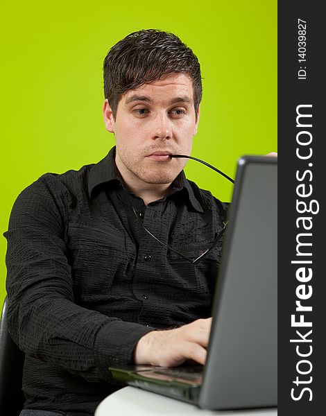 Young man sitting in the office and working on the laptop. Young man sitting in the office and working on the laptop