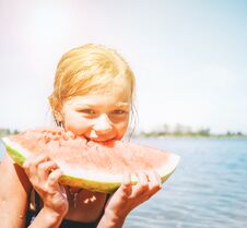 Free Little Smiling Girl Eating Red Watermelon Portrait On The Beach Stock Image - 140326571