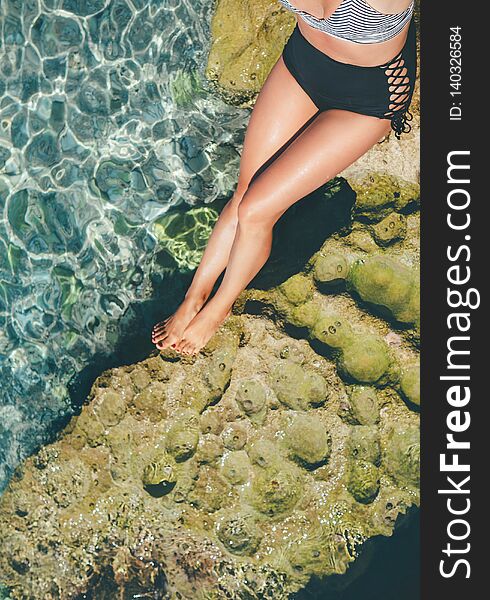 Sun buthing woman in retro swim suit close up legs image