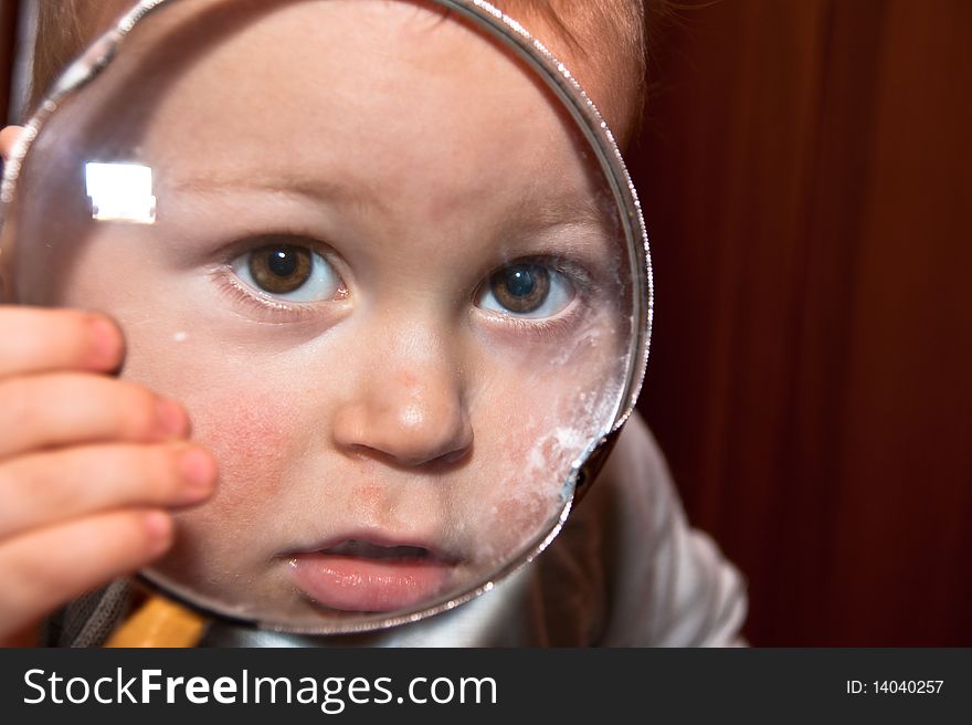 Young Baby Boy And Magnifying Glass