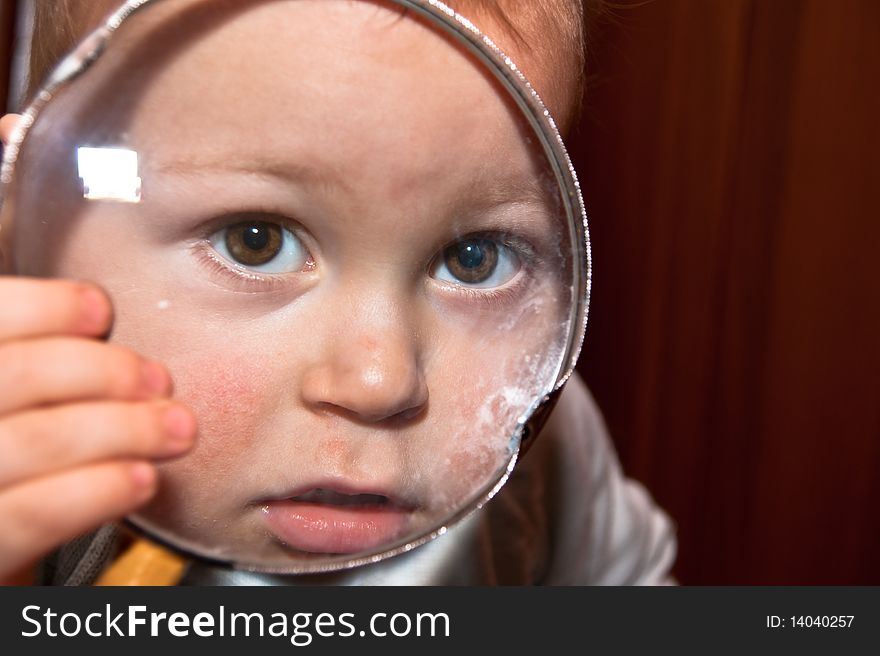 Young baby boy and magnifying glass, 2010