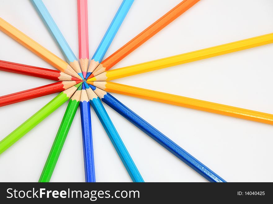 Colorful wooden color pencil in round with white floor background