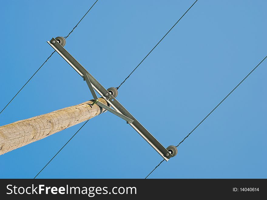 Wooden electricity pole with cables on rich blue sky. Wooden electricity pole with cables on rich blue sky