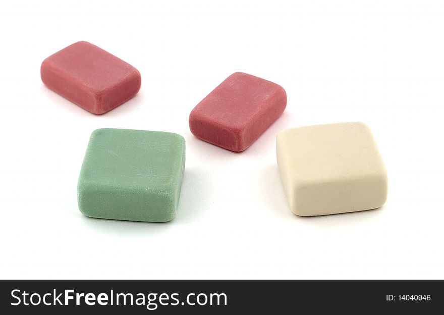 Erasers in various colors on a white background