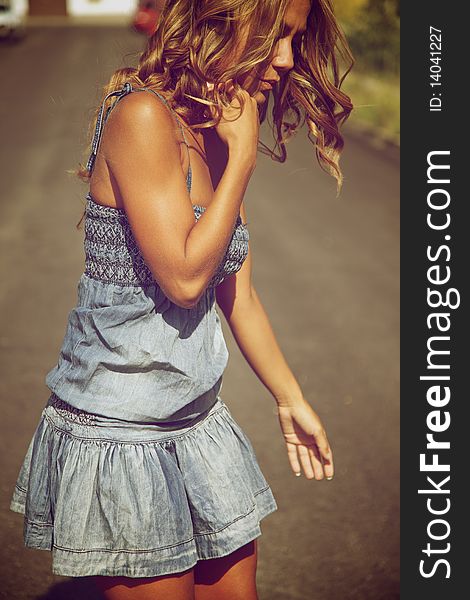 Beautiful fashion female model posing outdoors on a summer day. Beautiful fashion female model posing outdoors on a summer day.