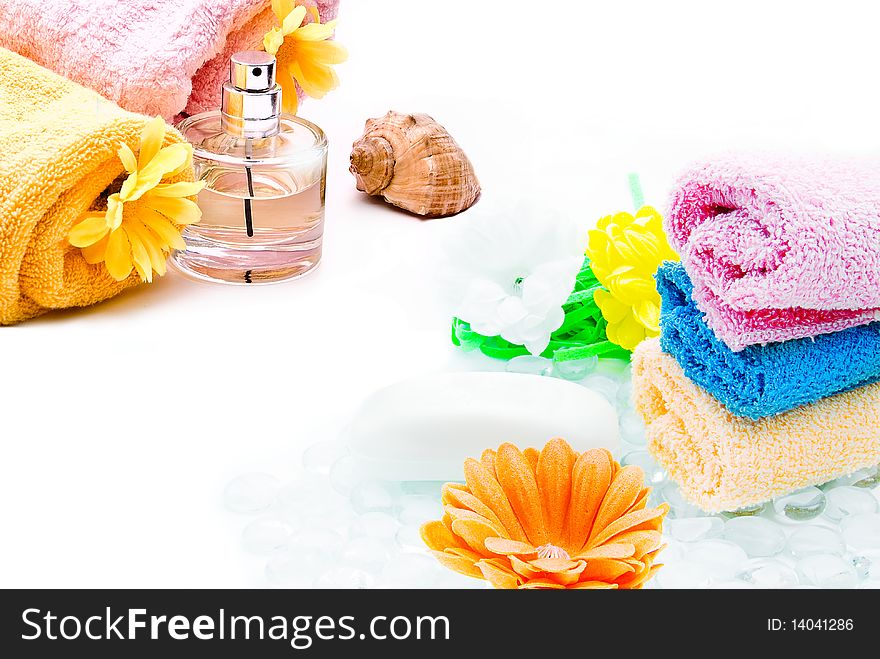 Spa towels with flower and bottle of perfume