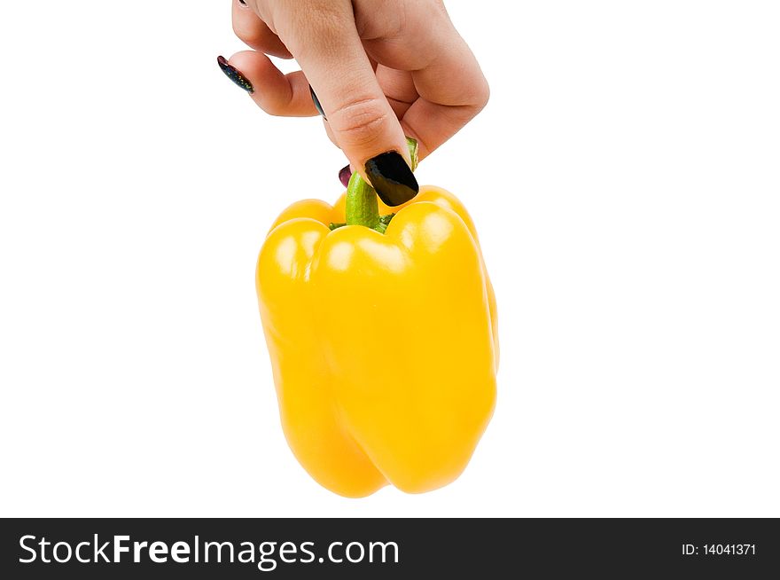 Juicy, yellow pepper in a hand, it is isolated on a white background.