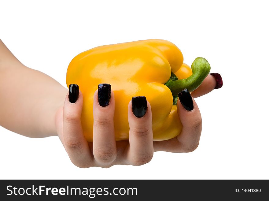 Juicy, yellow pepper in a hand, it is isolated on a white background.