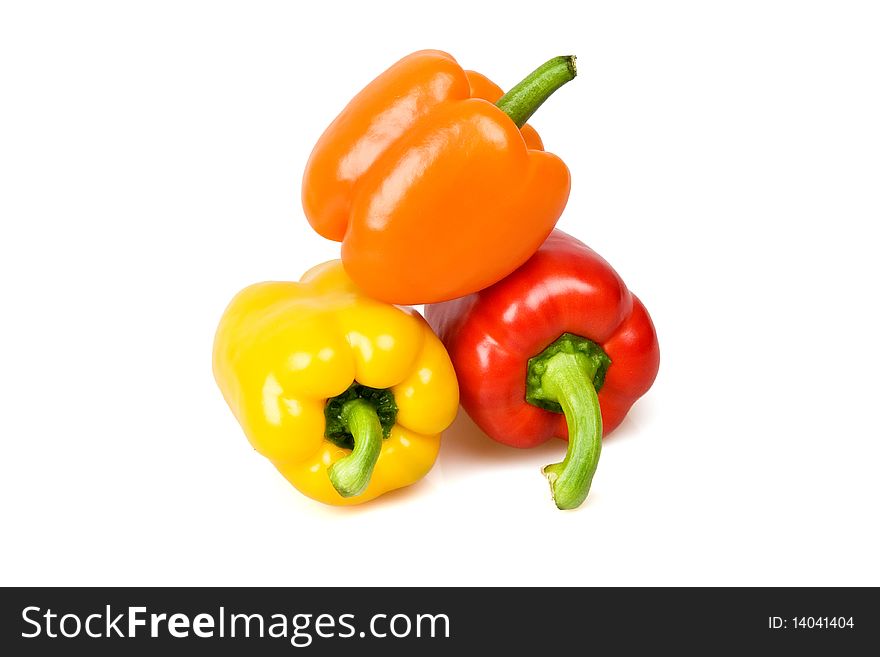 Red, yellow and orange bell peppers isolated on white.