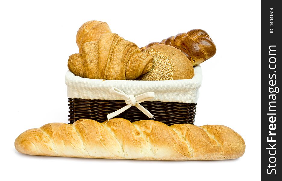Fresh bread rolls in a basket on whitete