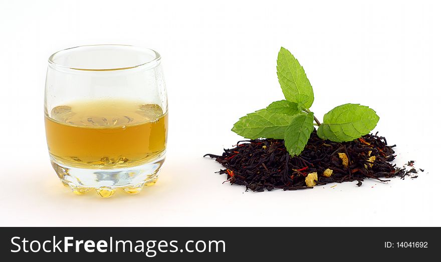 Still life of tea with spearmint on a white. Still life of tea with spearmint on a white