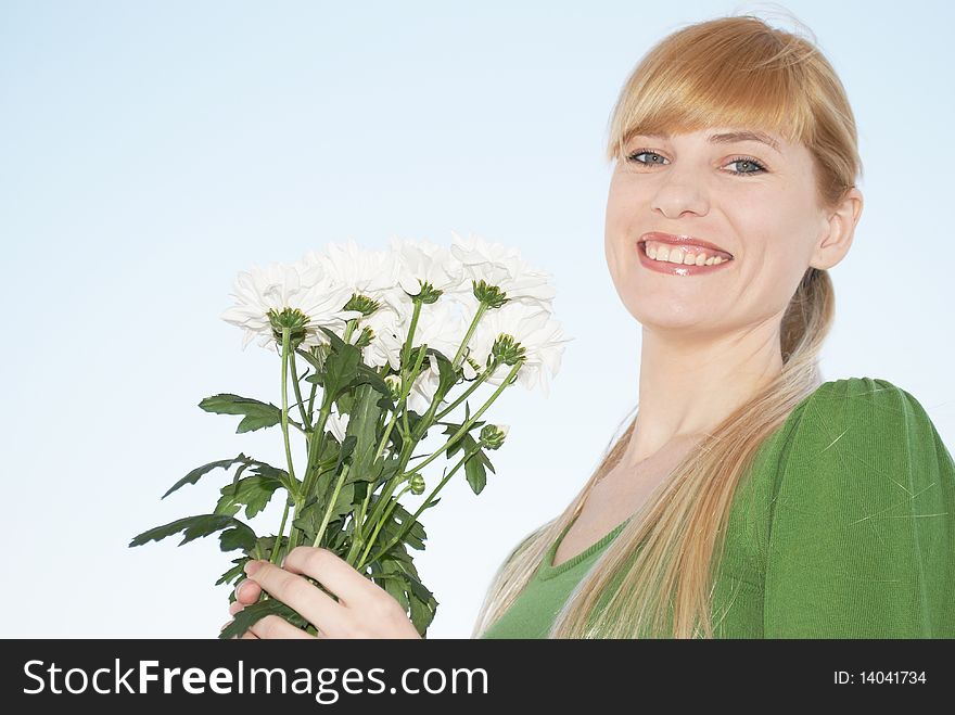 The young woman with a bouquet of colors on a background of the sky