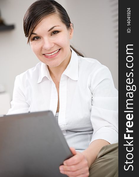 Happy attractive young woman at sofa with laptop. Happy attractive young woman at sofa with laptop