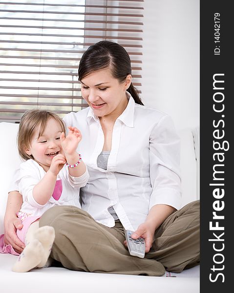 Mother and daughter having fun on sofa. Mother and daughter having fun on sofa