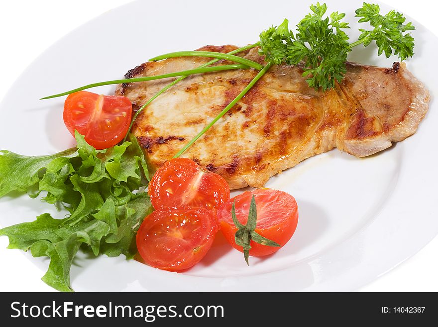 Meat with fresh vegetables and salad on white background