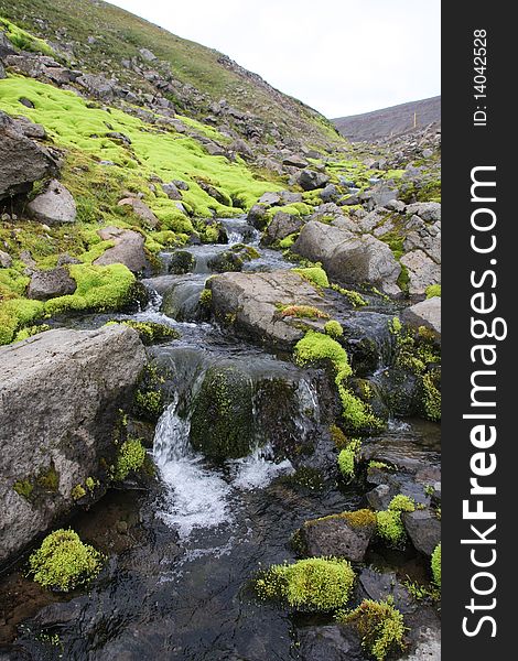 Nice stream with green moss between the gray rocks. Nice stream with green moss between the gray rocks