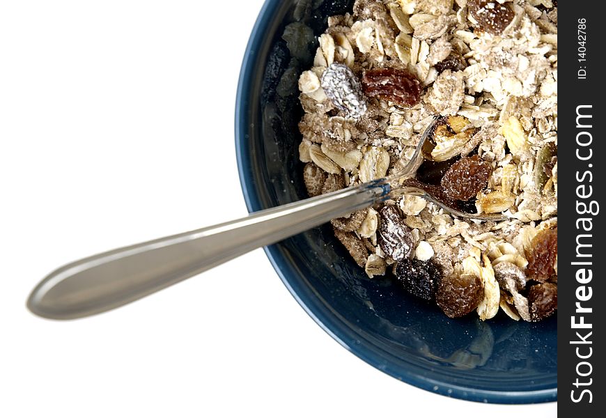 A bowl with muesli on white background and a spoon