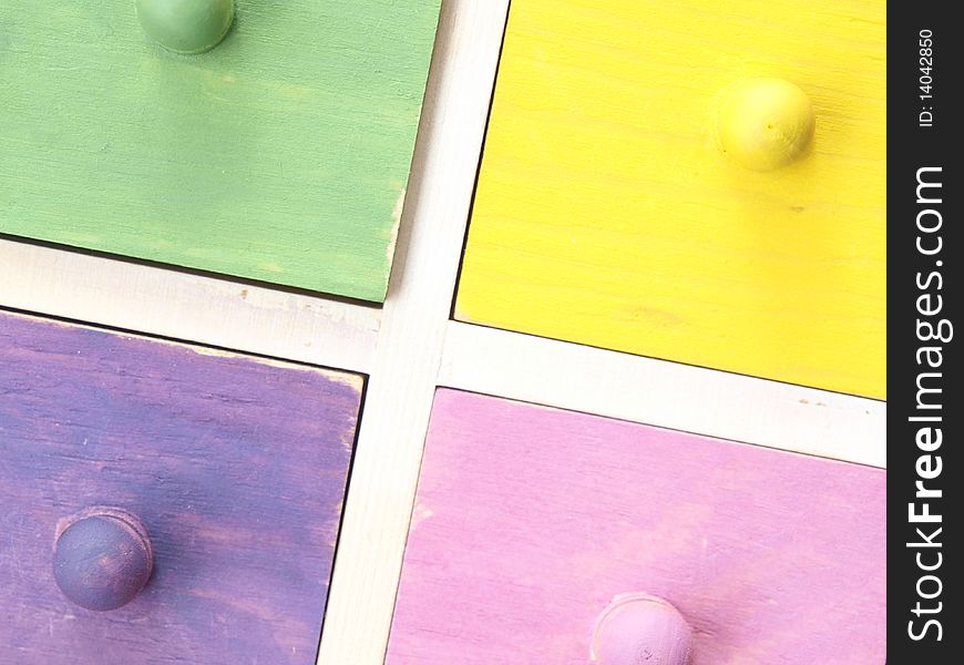 Colourful wooden drawers in yellow and pink and green and purple. Colourful wooden drawers in yellow and pink and green and purple