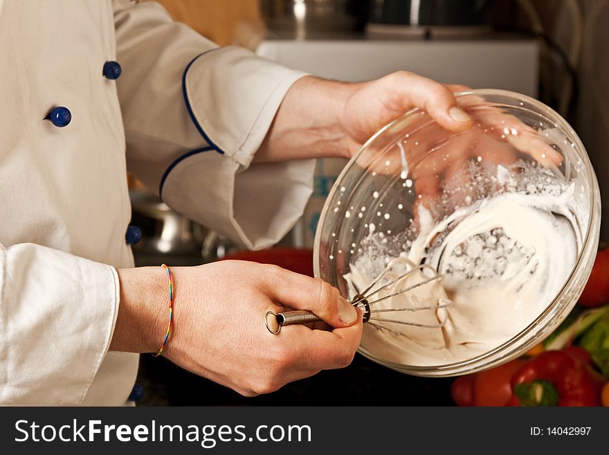 Man S Hand Whisk Whips Cream In A Glass Dish