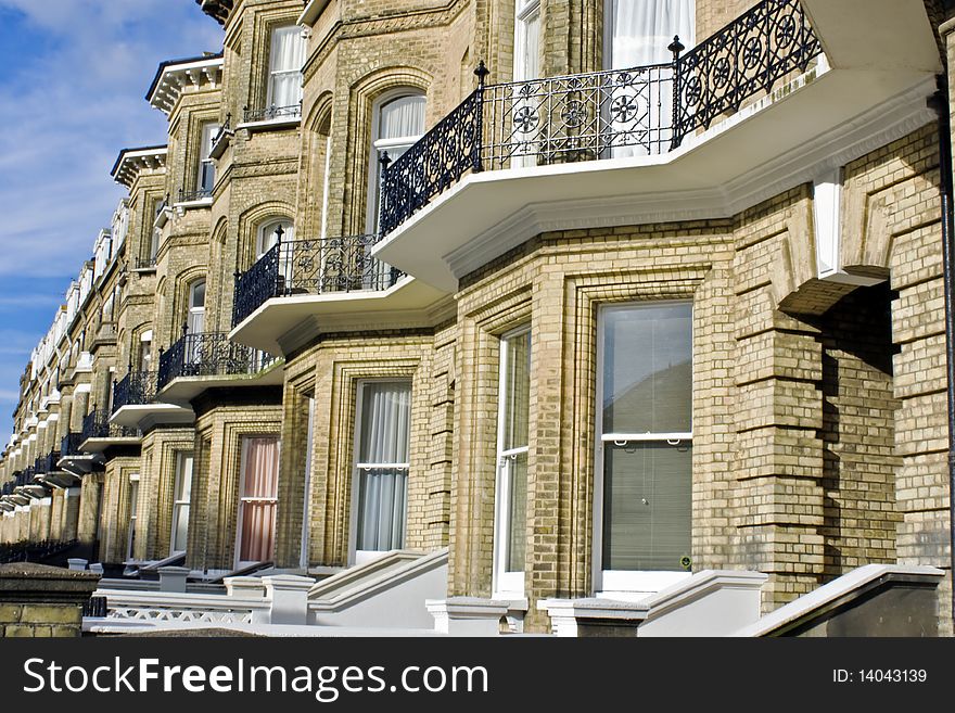 A terrace of yellow brick Victorian houses with bay windows street Brighton Sussex. A terrace of yellow brick Victorian houses with bay windows street Brighton Sussex