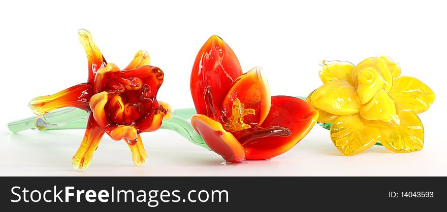 Flowers of colored glass (souvenir) closeup isolated on white