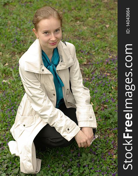 A girl sitting on the field