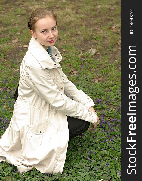 A girl sitting on the grass and flovers. A girl sitting on the grass and flovers