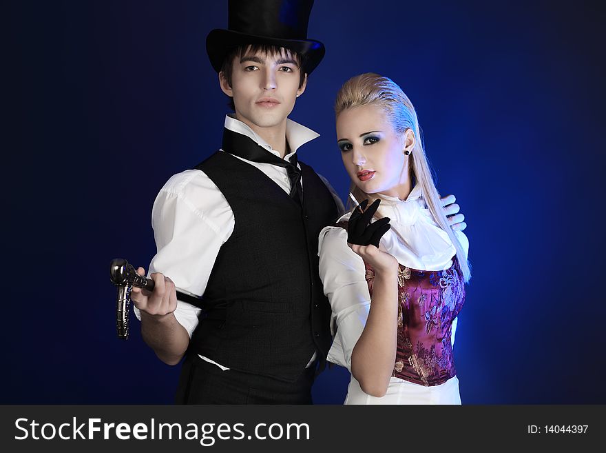 Portrait of the elegant young couple in 18, 19th century costumes. Shot in a studio.