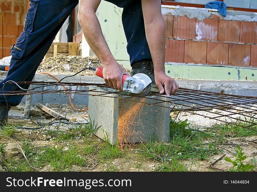 Man working with handtool on construction site. Man working with handtool on construction site