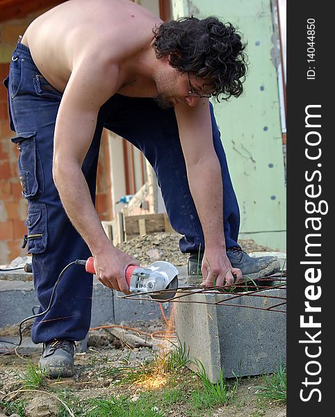 Man working with handtool on construction site. Man working with handtool on construction site