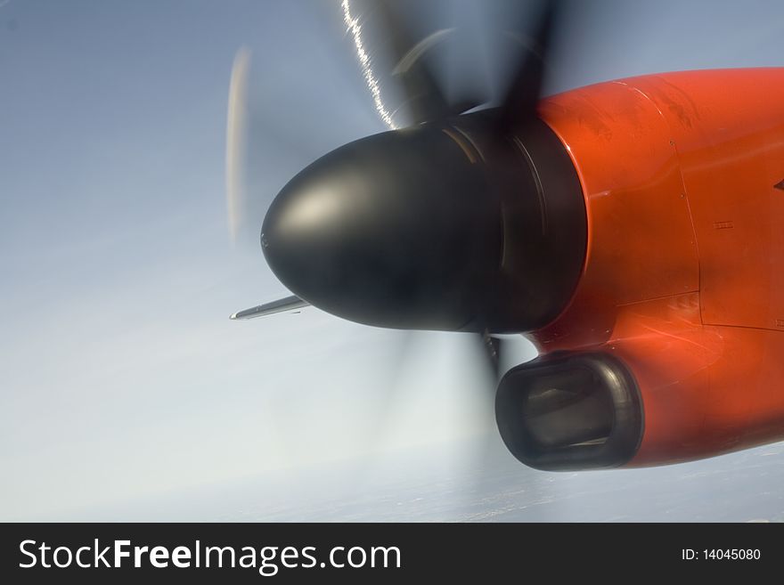 Black airplane propeller spins in the sky