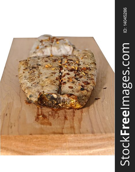 Pieces of seasoned Mahi on a cedar plank used for grilling. Pieces of seasoned Mahi on a cedar plank used for grilling.