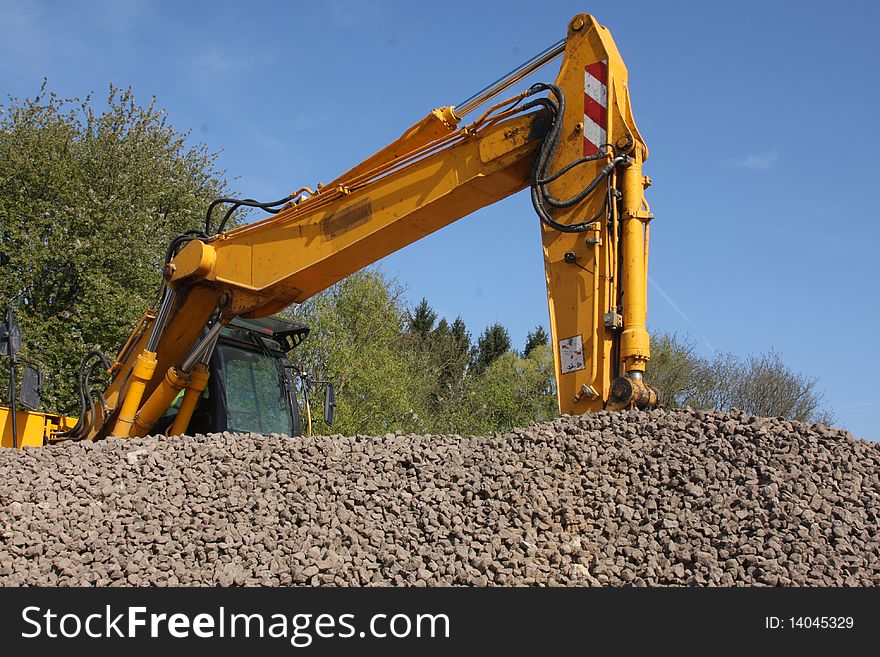 Digger at Work on a Pile of Rubble