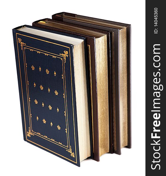 Three vintage-style hardcover books, standing on end, and isolated on a white background. Three vintage-style hardcover books, standing on end, and isolated on a white background.