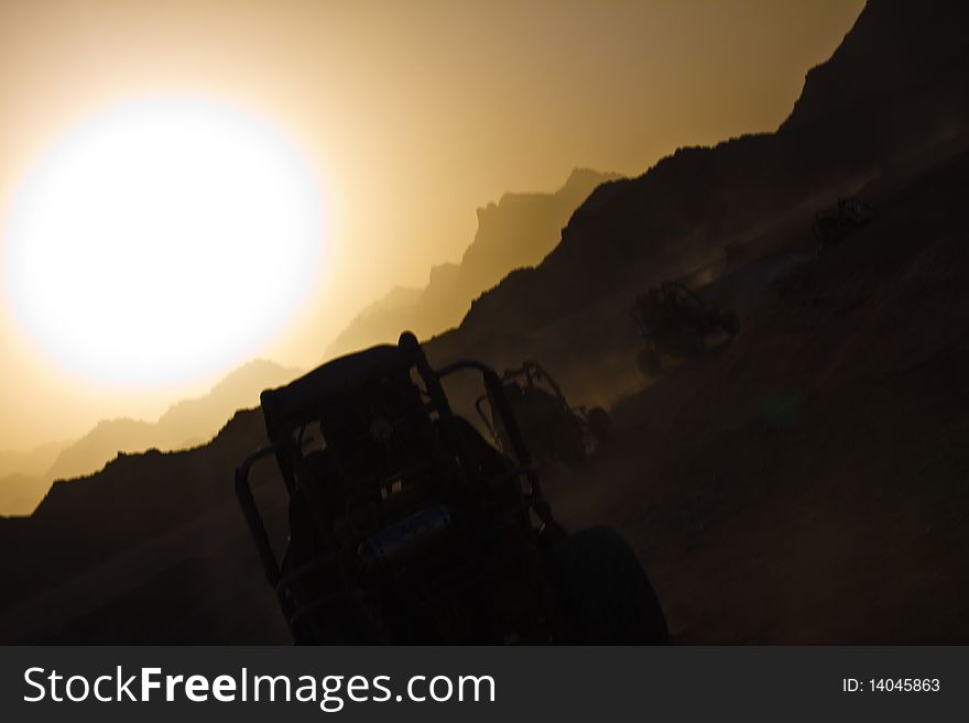 Buggy in the sunset in desert. Buggy in the sunset in desert