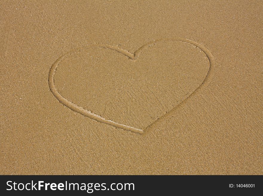 Heart drawn on sand on the seashore. Heart drawn on sand on the seashore