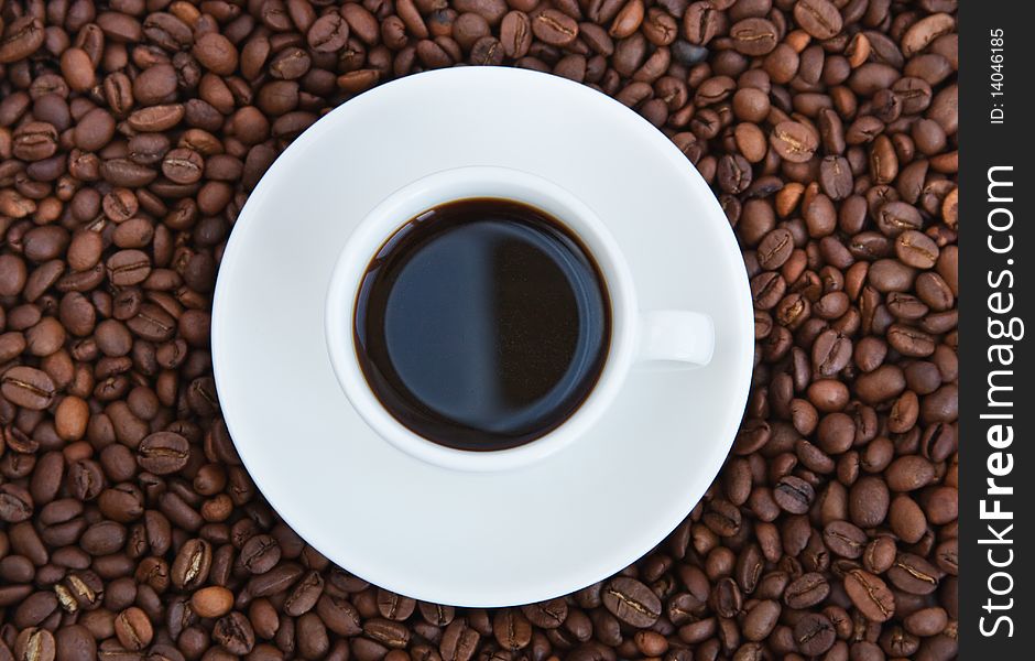 Cup with coffee standing on coffee grain. Cup with coffee standing on coffee grain