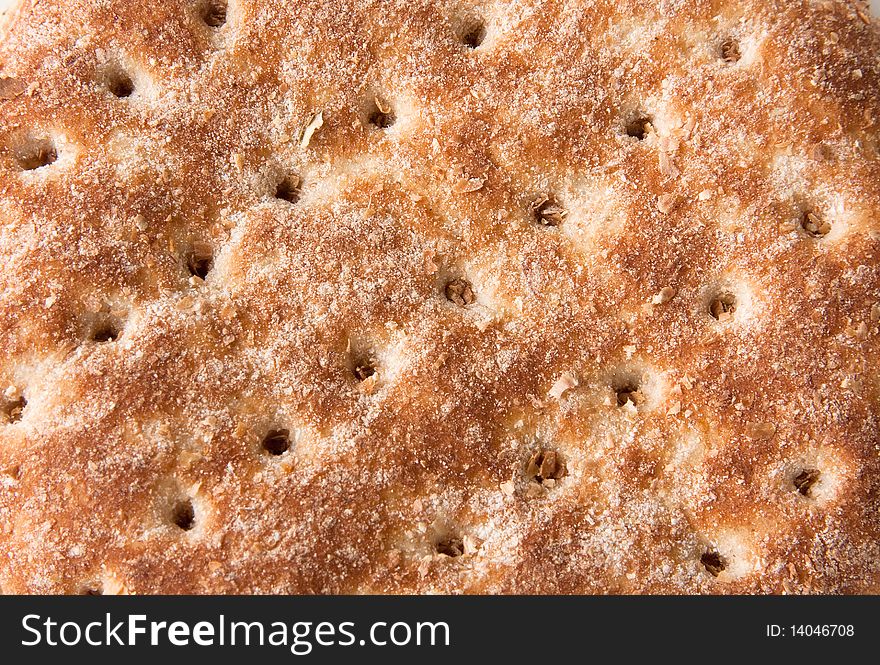 Closeup detail of top of bread bun with holes in diagonal pattern. Closeup detail of top of bread bun with holes in diagonal pattern